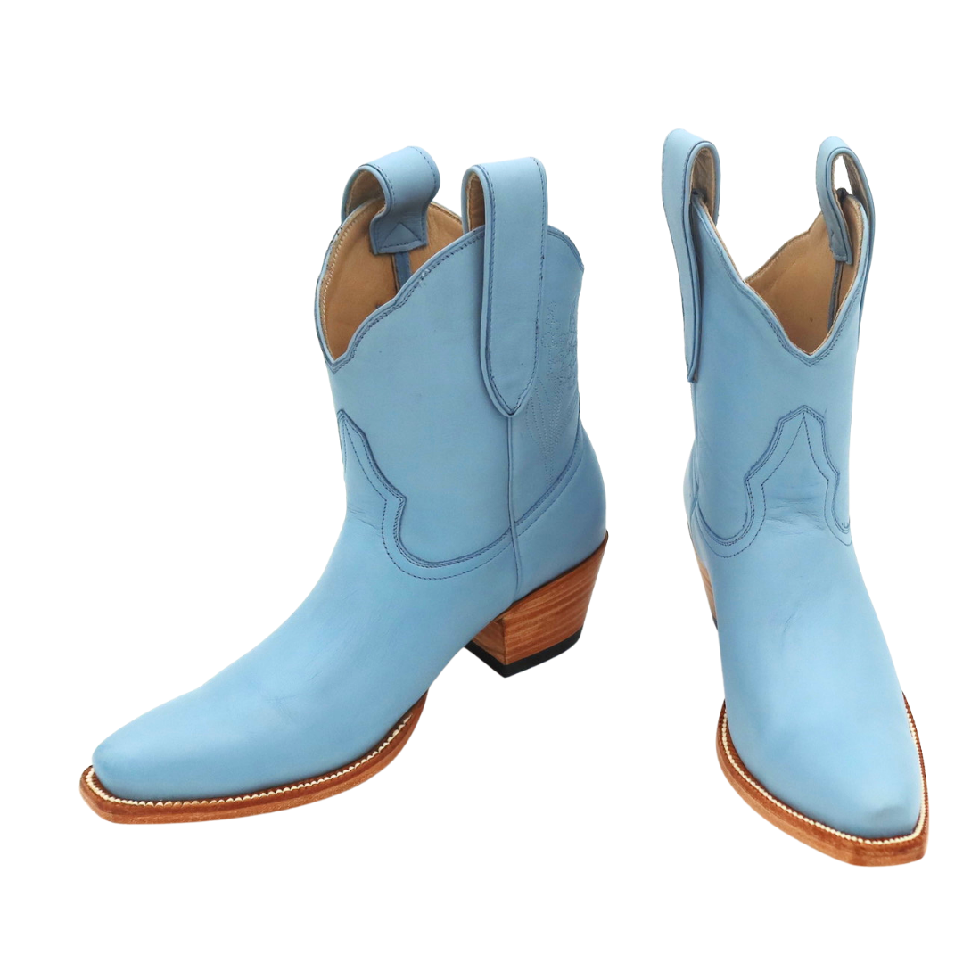 Pair of light blue cowboy boots with lily of the valley embroidered on the back of shaft luxury cowgirl cowboy boot bespoke handcrafted handmade on a white background