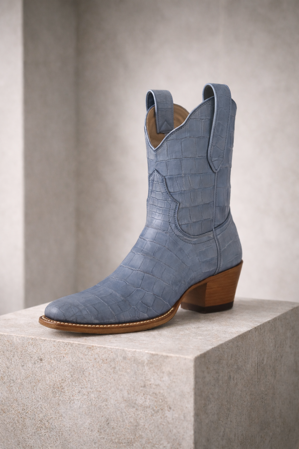 Denim blue American Alligator cowgirl cowboy boot on a light gray background