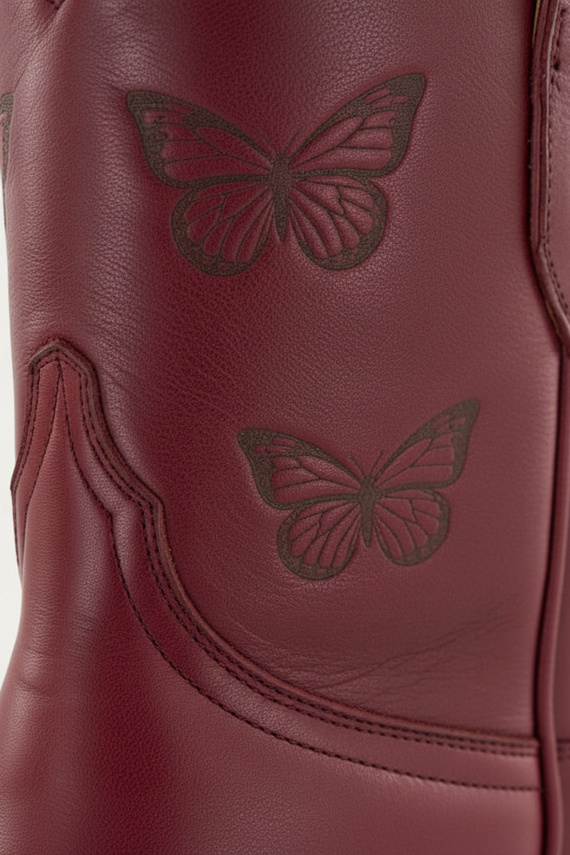 Red Maroon Burgundy Crimson cowgirl cowboy boot with a butterfly design on a white background