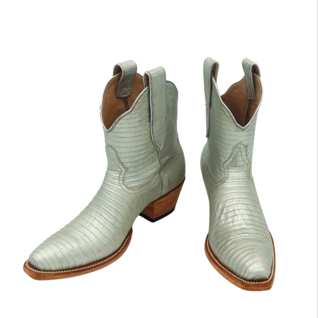 Pair of silver lizard luxury cowgirl cowboy boot with brown soles on a white background