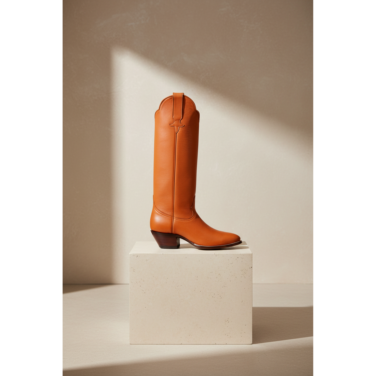 Chestnut tall boot on a square pedestal.