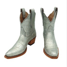 Pair of luxury silver alligator cowgirl / cowboy boots on a white background