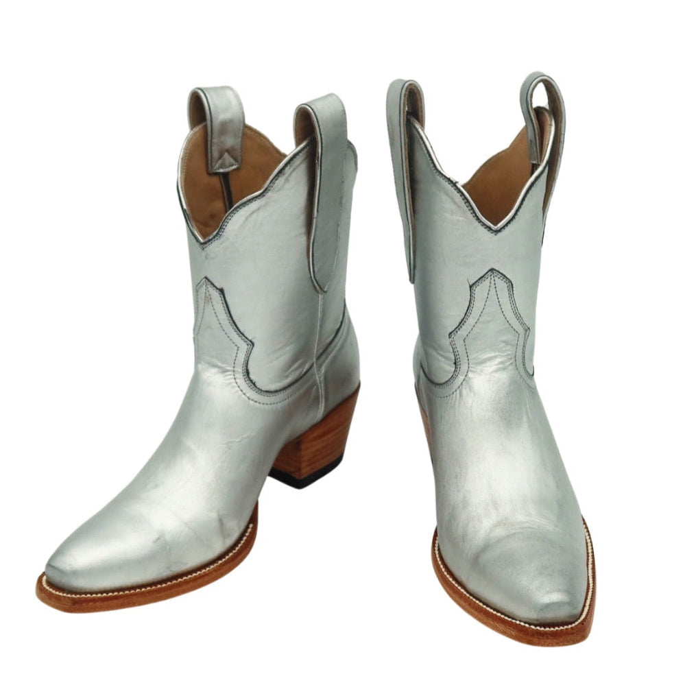 Pair of silver luxury cowgirl cowboy boots on a white background