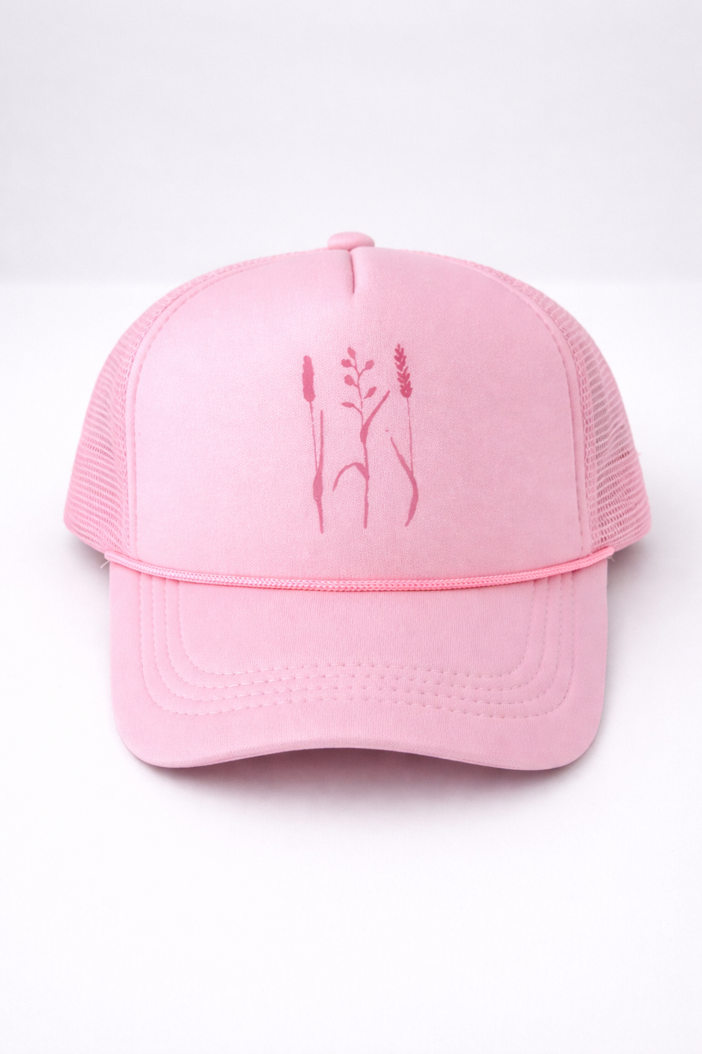 Pink cap with embroidered design on a white background