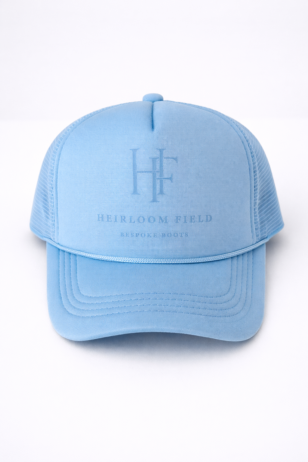 Light blue cap with 'Heirloom Field' logo and text on a white background