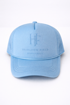 Light blue cap with 'Heirloom Field' logo and text on a white background
