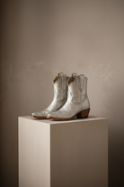 The Payton Boot — Silver Metallic Lizard — Side profile showing architectural silhouette and stacked leather heel
