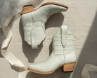 Pair of light gray chalk ivory cream ankle boots with wooden soles on a neutral background tule ribbon bridal alligator exotic short luxury boot cowgirl cowboy white