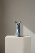 The Payton Boot — Denim Blue Alligator — Side profile showing architectural silhouette and stacked leather heel