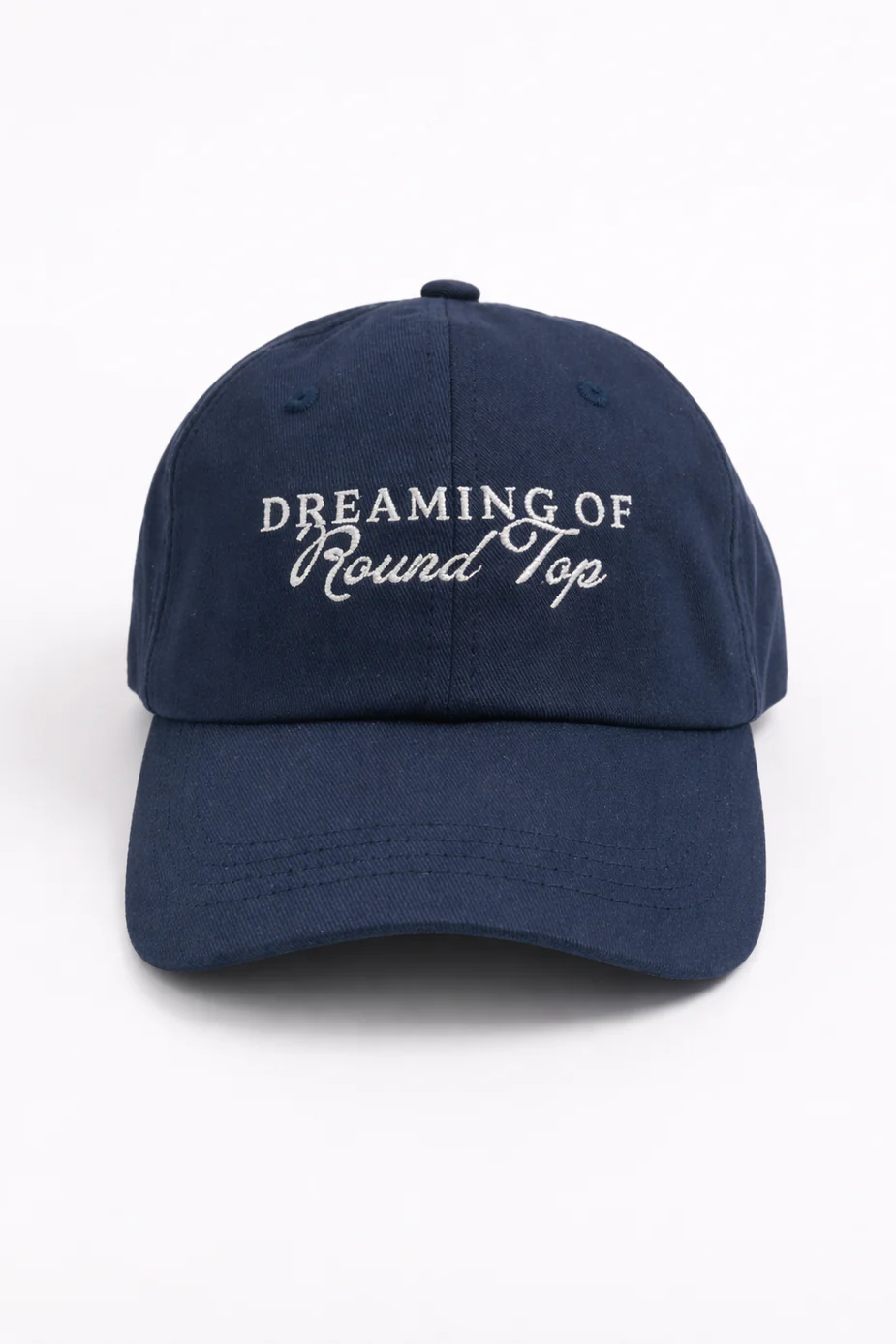 Front of the navy Dreaming of Round Top cap with white embroidered lettering.