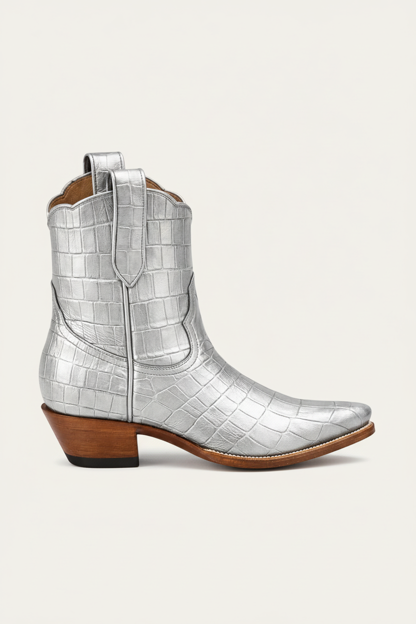 Silver crocodile-patterned cowboy boot with a brown heel on a white background