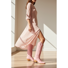 Pink Buttercup boots worn with a flowing pink dress