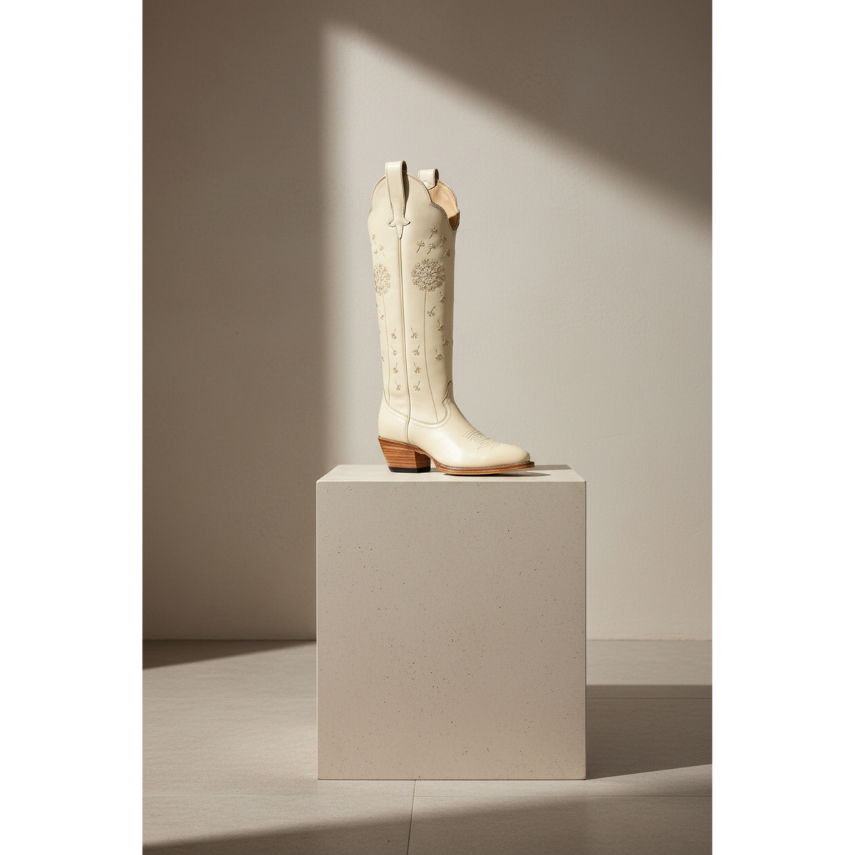 Dandelion boot displayed on a pedestal.