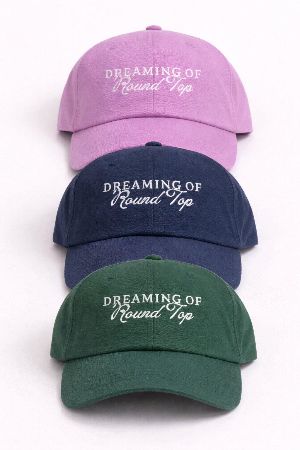 Dreaming of Round Top caps in lavender, navy, and hunter green, shown together from the front.