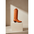 Chestnut tall boot on a square pedestal.