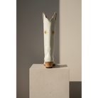 Gold Flower boot displayed from the back on a pedestal.