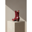 Rear and side views of maroon Mariposa boots on a pedestal.
