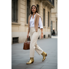 Gold Metallic Payton boots worn with cream trousers on a city street