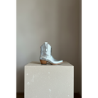 The Payton Boot — Silver Metallic — Side profile showing architectural silhouette and stacked leather heel