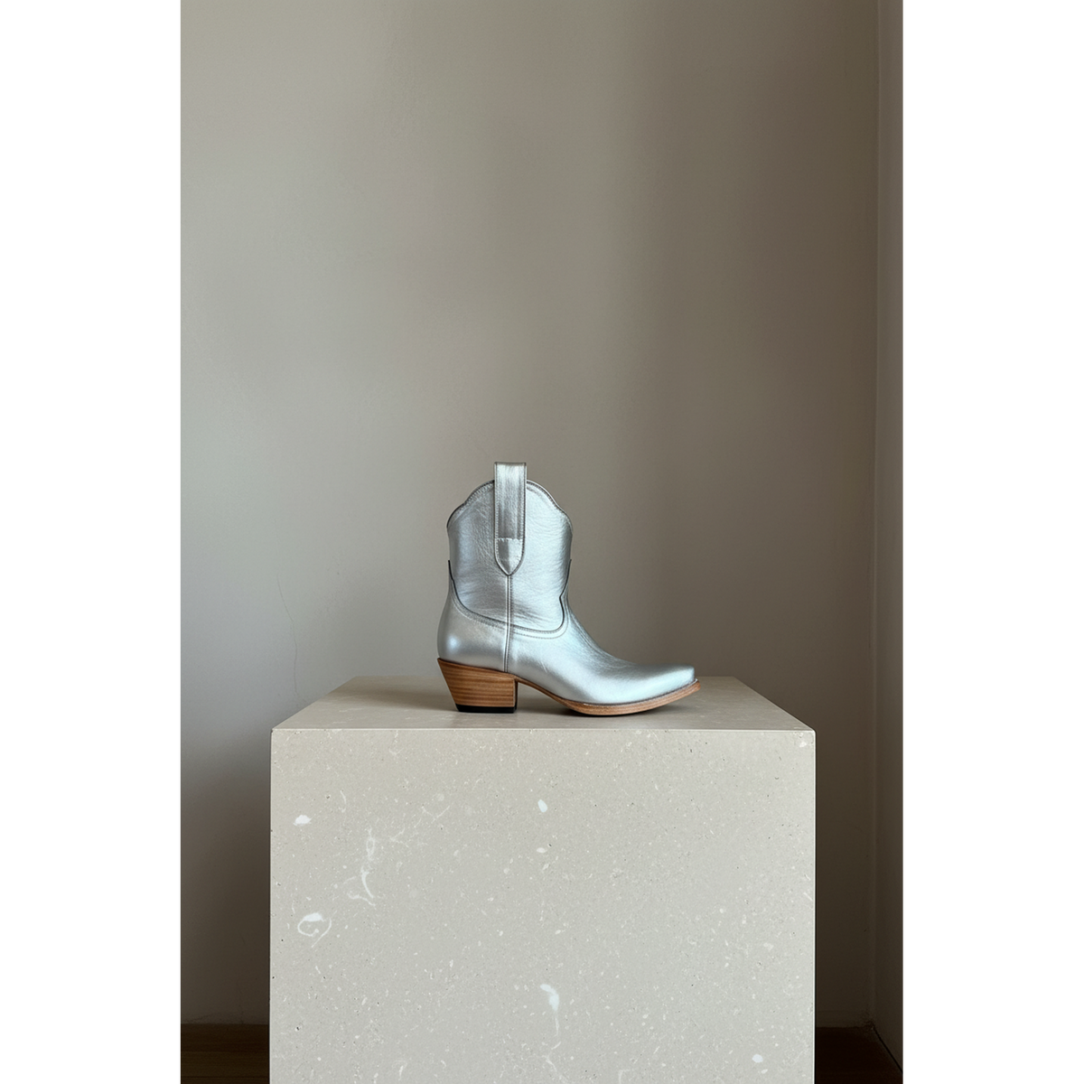The Payton Boot — Silver Metallic — Side profile showing architectural silhouette and stacked leather heel