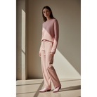 Woman styling Petal Pink Payton boots with a tonal pink sweater and trousers.