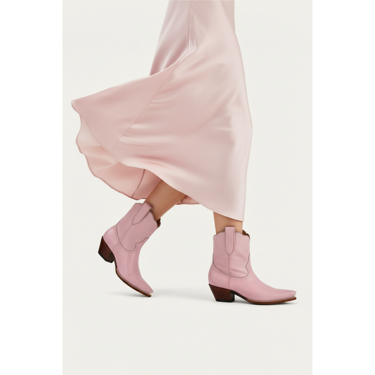 Petal Pink Payton boots beneath a flowing pink skirt.