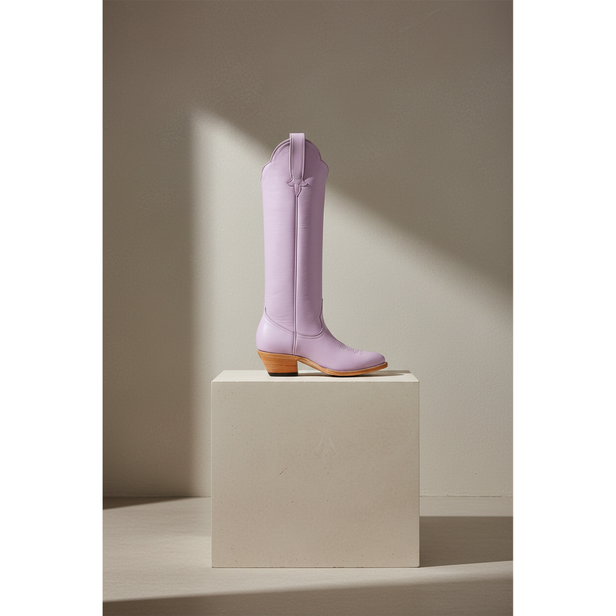Lavender Georgia Tall boot, side view on a stone pedestal