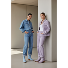 Two women in blue denim and lavender tailoring wearing blue and lavender boots.