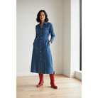 Woman in a blue denim dress wearing red boots