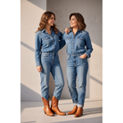 Two women in denim outfits wearing brown boots.