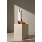 Chestnut and Bone Wheat boot on a pedestal in sunlight